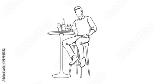 Man sitting at a bar table with a drink.