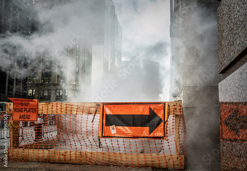 Moody urban street scene with fog and construction barriers