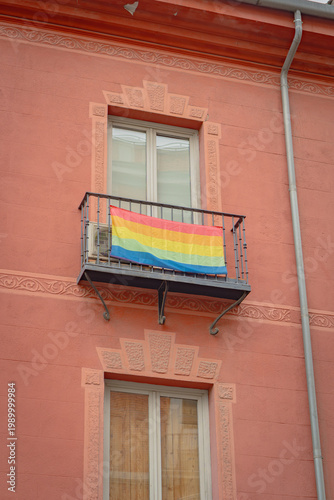 Pride flag in a window on the streets of Madrid