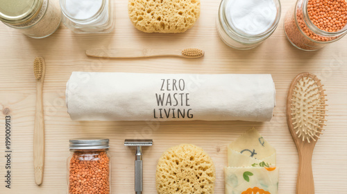 Zero waste living concept with eco friendly personal care items including bamboo toothbrush, reusable razor, natural sponge, and glass jars on wooden surface