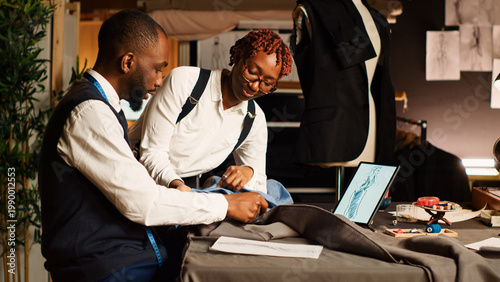 Εκτύπωση καμβά Tailor and assistant picking fabric to create modern clothes, working in atelier to craft clothing items for fashion collection
