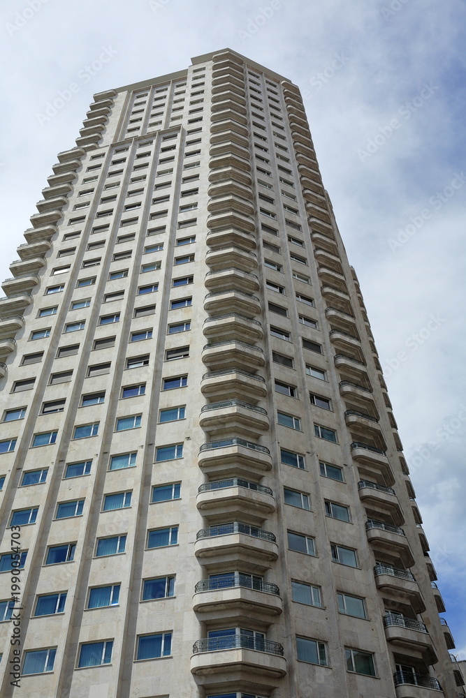 Fototapeta premium Modern Residential High-Rise Building with Repetitive Balconies in Madrid