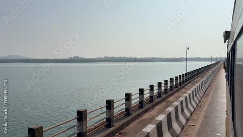 A bus crosses the majestic Kali River in Karwar in stunning 4K, with calm waters, scenic bridges, and lush greenery creating a perfect blend of travel and coastal beauty.