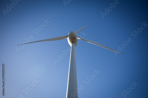 Wind turbine against clear blue sky