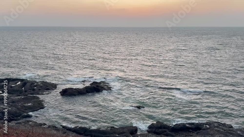 Beautiful 4K view of sea waves crashing against rugged rocks near Karhateshwar Mandir. Coastal breeze, endless blue waters, and serene Konkan beauty create a mesmerizing scene.