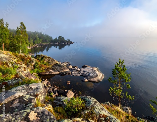 A serene rocky coastline with calm waters and lush greenery