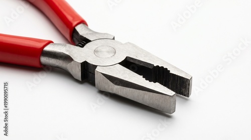 A pair of red-handled pliers rests on a white background, symbolizing utility, craftsmanship, and mechanical precision.