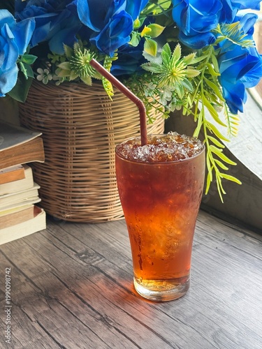Fotografie Refreshing Iced Americano coffee in a transparent glass at a modern cafe
