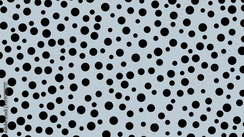 Black circles of different sizes on gray background.
