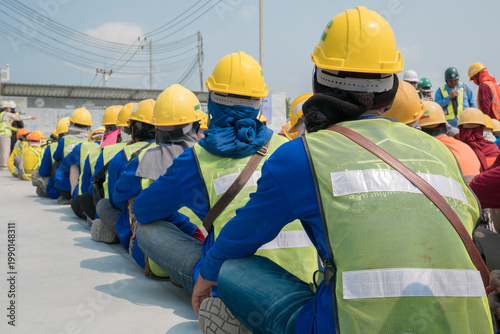 Schilderij op canvas Group of construction worker helmet and safety uniform meeting on morning talk b