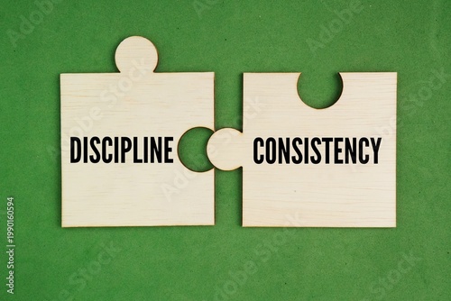Obraz na plátně Wooden puzzle with the words consistency and discipline