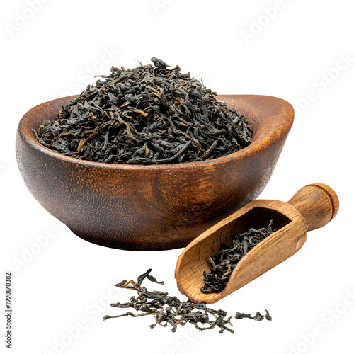 Loose leaf tea in wooden bowl with scoop on white background