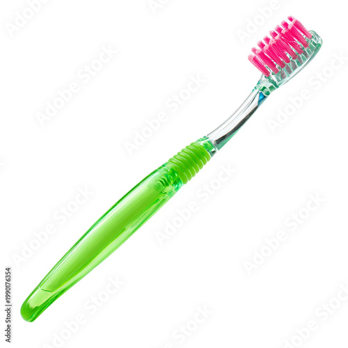 Close-up of green and pink manual toothbrush with soft bristles on white background