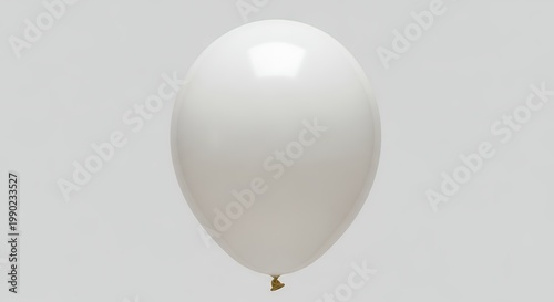 White Balloon Floating in Air Against a Light Gray Background.