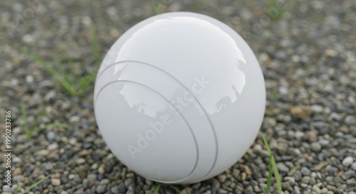 White Bocce Ball on Gravel Court, Close-Up View.