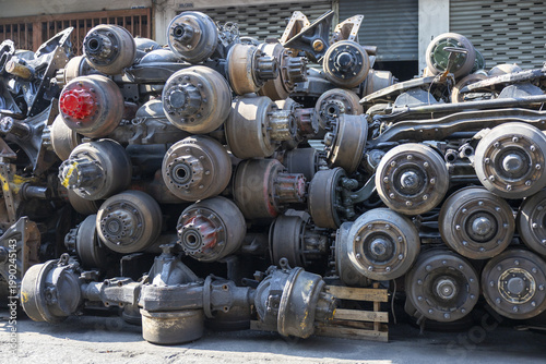 Photography Large pile of used heavy truck axles differentials and suspension components sta