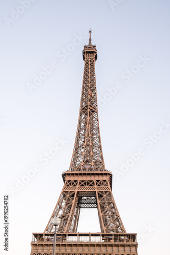 Paris, France – Detailed view of Eiffel Tower's iron lattice structure, built for 1889 World's Fair, masterpiece of 19th-century engineering and symbol of France.