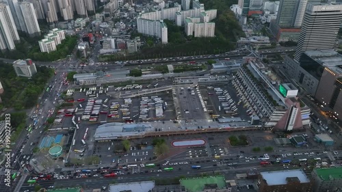 Aerial view of Seoul Express Bus Terminal at sunset with heavy traffic and city lights, Gangnam, South Korea.