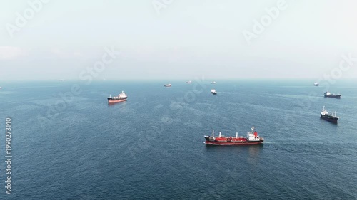 fast patrol boat LPG gas and oil tanker ships anchored in the ocean, with a fast patrol boat in the foreground. Global energy transport, war energy crisis, and Strait of Hormuz blockade