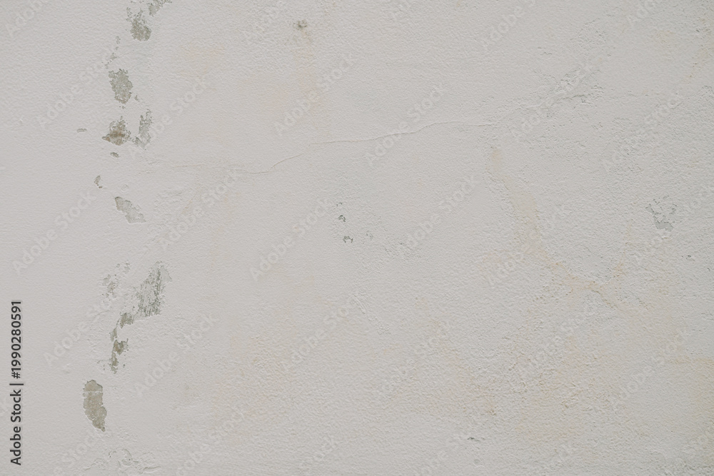 Fototapeta premium Closeup of a worn and weathered gray concrete wall with peeling paint