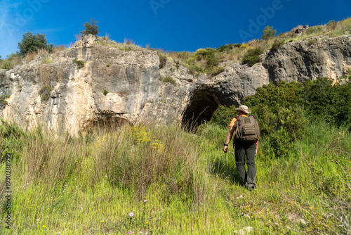 A hiker visiting a cave on the mountain