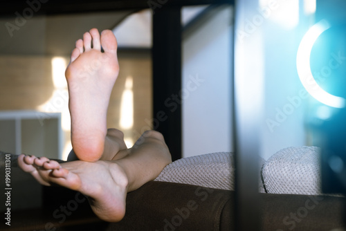 soft focus indoor shot of bare feet soles woman body part