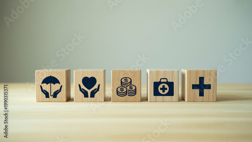 A collection of wooden blocks with various health and finance icons on a light wood surface