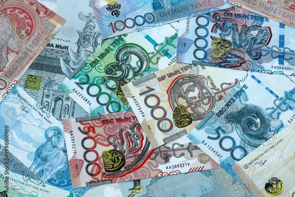 Fototapeta premium Kazakhstani tenge money banknotes pile on table. Kazakhstan bills of KZT currency close up