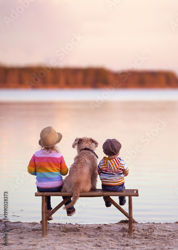 cute boy and girl sitting on a wooden bench