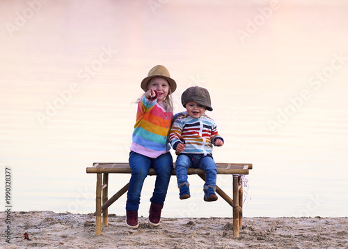 Children Enjoying Warm Spring by the sea