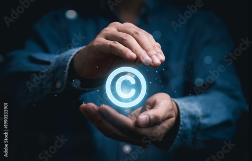 фотографія Copyright protection concept with glowing copyright symbol in hands represent intellectual property rights, digital ownership, legal security, content protection, and safeguarding creative assets