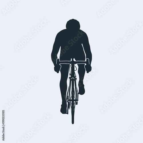 Silhouette of a cyclist riding a road bike, frontal view of a professional athlete training on a bicycle.