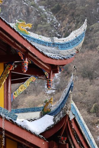 Ancient Chinese architecture flying eaves with ornate rooftops of Huanglong Ancient Temple in Huanglong National Park, Songpan County, Sichuan Province of China