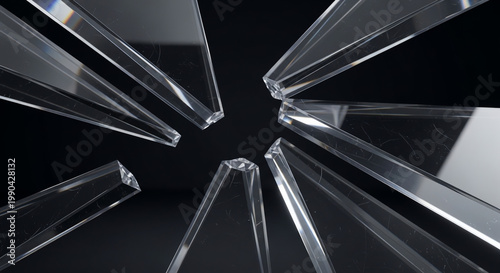 Abstract close-up view of sharp, clear glass shards radiating from a central point against a dark background.