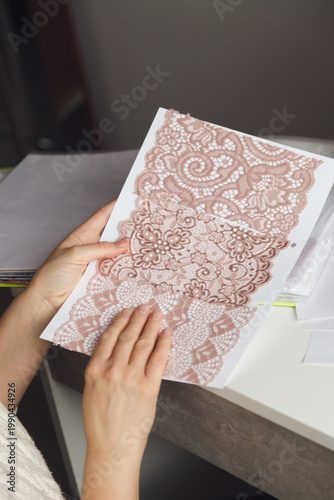 Fashion Designer Reviewing Lace Fabric Sample at Workspace