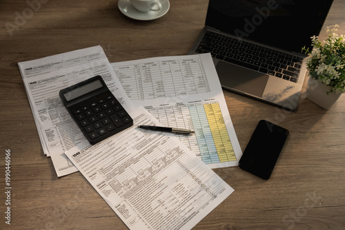 Billede på lærred Organized tax filing workspace featuring calculator, laptop, mobile phone, and d