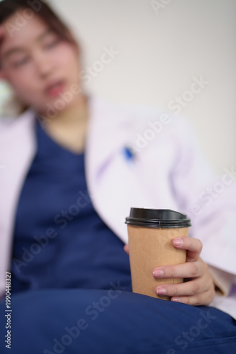 Foto Healthcare worker experiencing burnout and fatigue, holding a cup of coffee and