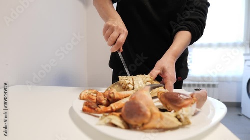 Slicing succulent crab on a sunny afternoon at home