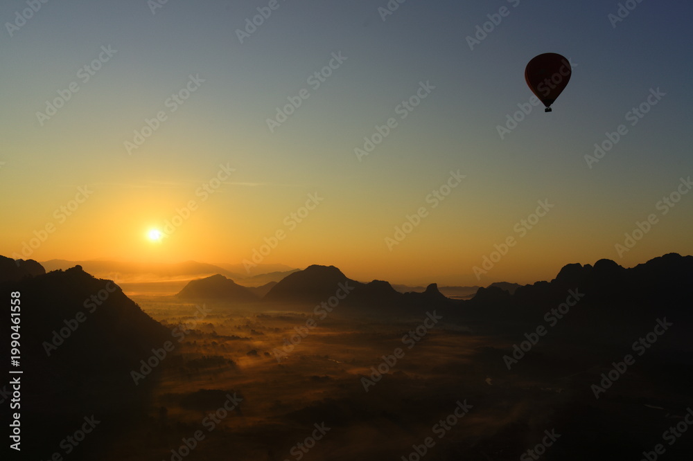 Fototapeta premium flying hot air balloon at sunrise