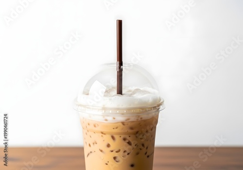 A refreshing iced coffee beverage with frothy cream enjoys a pleasing presentation upon the wooden table, inviting indulgence into its flavorful layers, ensuring it’s a delectable treat anyone