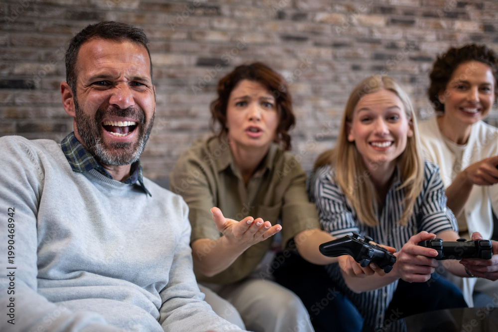 Fototapeta premium Friends playing video games having fun and competition
