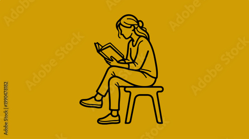 Woman engrossed in reading a book while sitting on a stool.