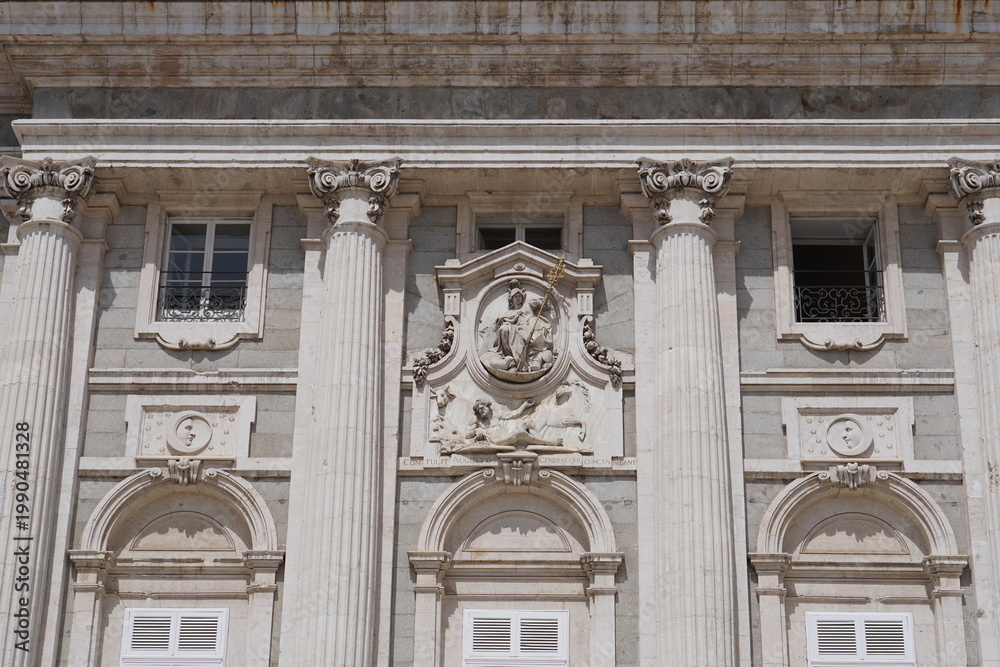 Fototapeta premium Ornate Stone Relief Sculpture and Corinthian Columns on Royal Palace Facade Madrid