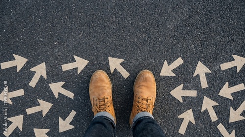Person standing among directional arrows on asphalt background
