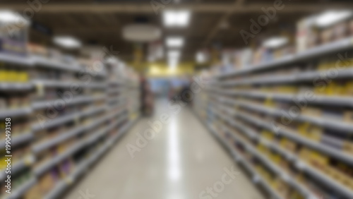 Blurred View of Supermarket Aisles with Shelves Stocked with Products.