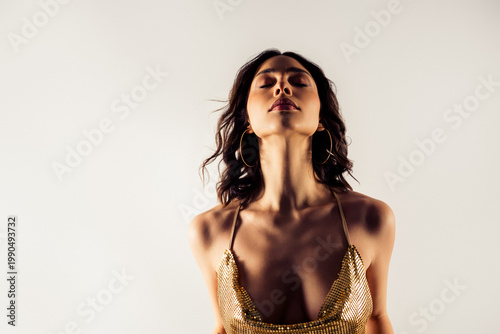 Quadro su tela Confident woman in gold sequin dress portrait with eyes closed, elegant fashion