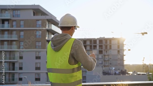 Quadro em tela Man constructive engineer with white hard hat and safety vest is using a tablet