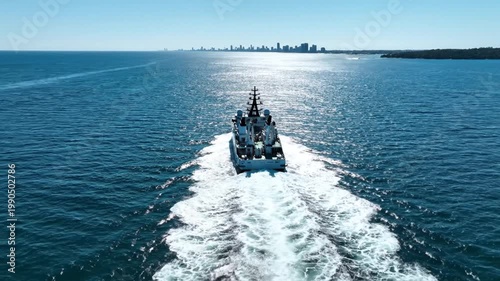 Modern research vessel cruising toward a distant city skyline