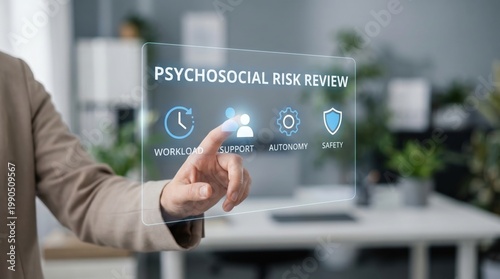 psychosocial risk - A bare hand interacts with a modern psychosocial risk management digital interface in a cinematic, realistic medium close-up.