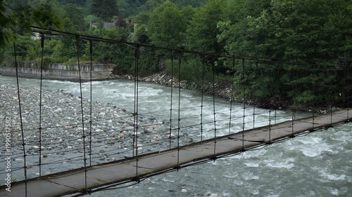 The flow of a mountain river and a bridge